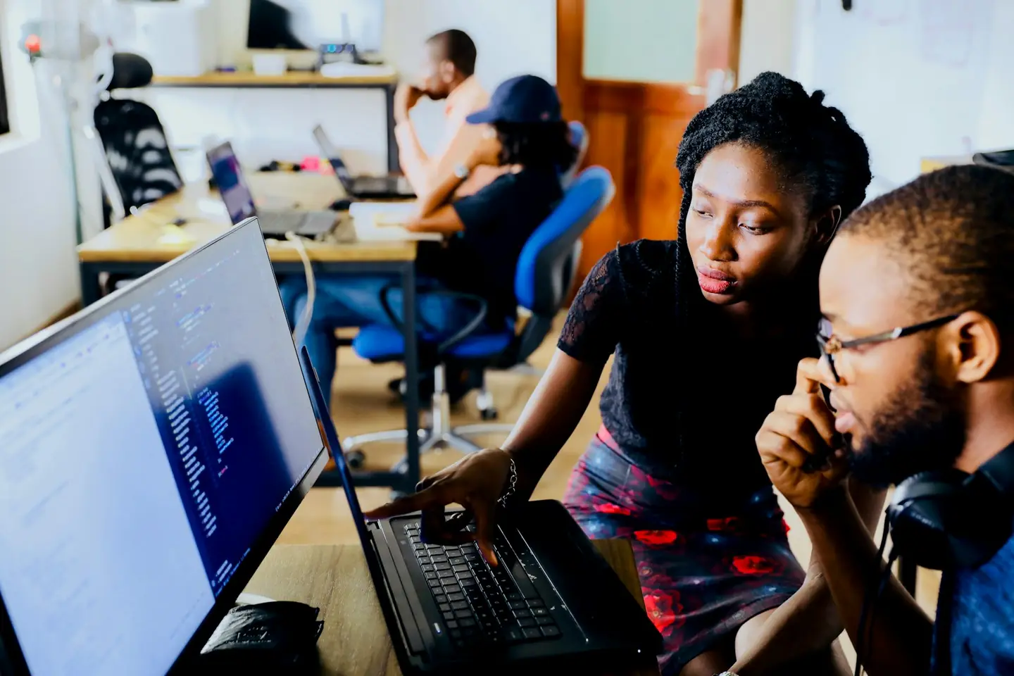 Two analysts reviewing data together at a desk